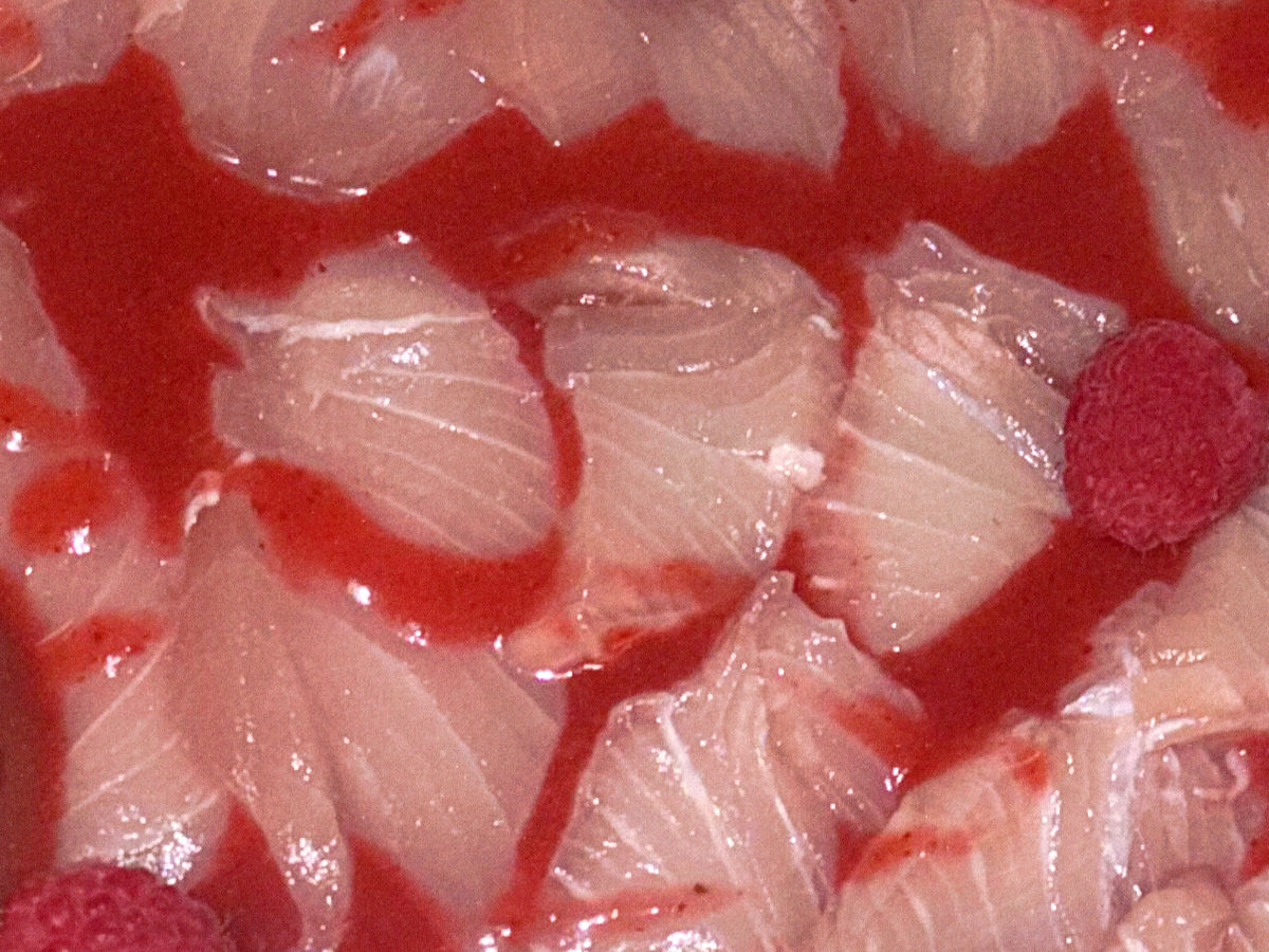 Spicy strawberry aguachile crudo plated with sliced yellowtail